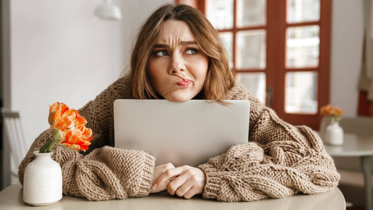 A young woman making a concerned facial expression.